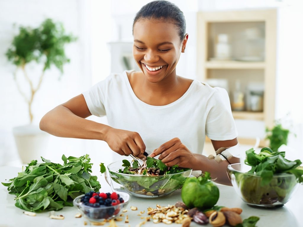 3.2-a-person-joyfully-preparing-a-nutritious-meal-in-a-bright-kitchen-with-fresh-ingredients-like-leafy